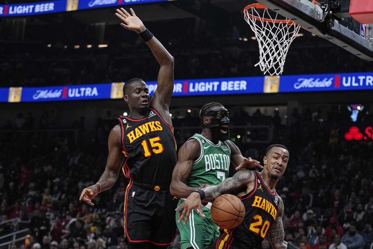 Atlanta Hawks' Clint Capela (15) and John Collins (20) fight for the rebound against Boston Celtics' Jaylen Brown (7) during the first half of Game 6 of a first-round NBA basketball playoff  ...