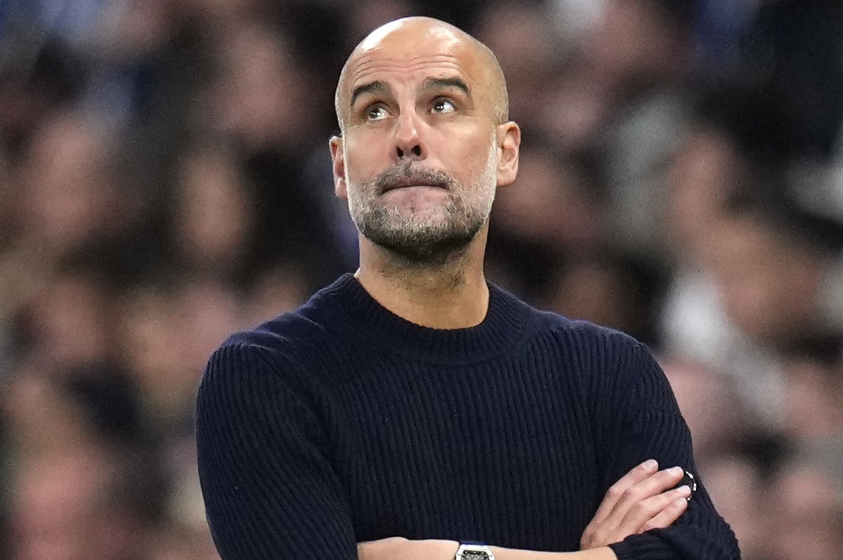 Manchester City's head coach Pep Guardiola gestures during the Champions League playoff second leg soccer match between Real Madrid and Manchester City at the Santiago Bernabeu Stadium in Madrid, ...