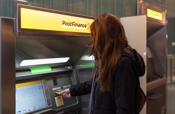 ARCHIVBILD --- Cash withdawal by a customer at a cash dispenser of PostFinance at Rennweg in Zurich, Switzerland, on October 30, 2018. (KEYSTONE/Christian Beutler)..Bargeldbezug einer Kundin an einem  ...