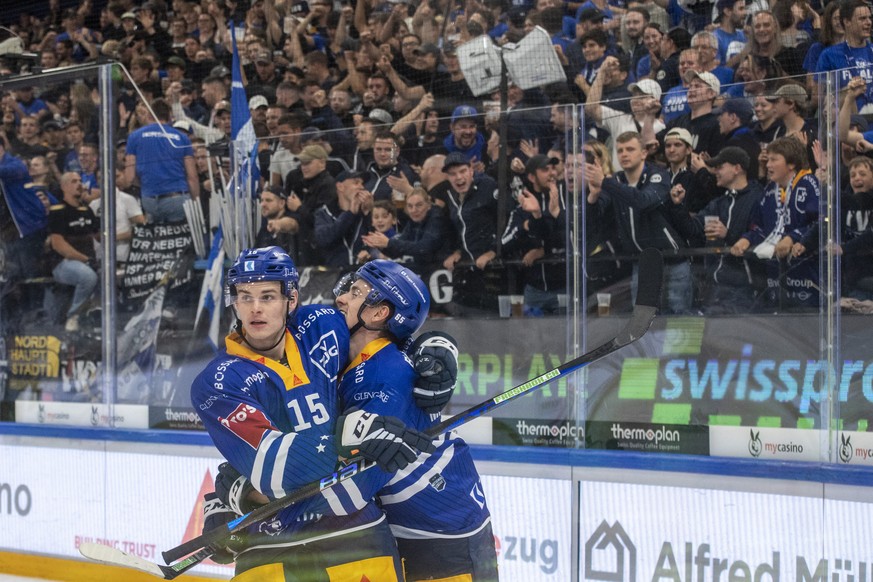 The Zugers with Gregory Hoffman, left, and Mark Michaelis, right, celebrate the goal that made it 6-0 in the NHL championship game between EV Zug and HC Ajoie on Saturday, Oct. 14...