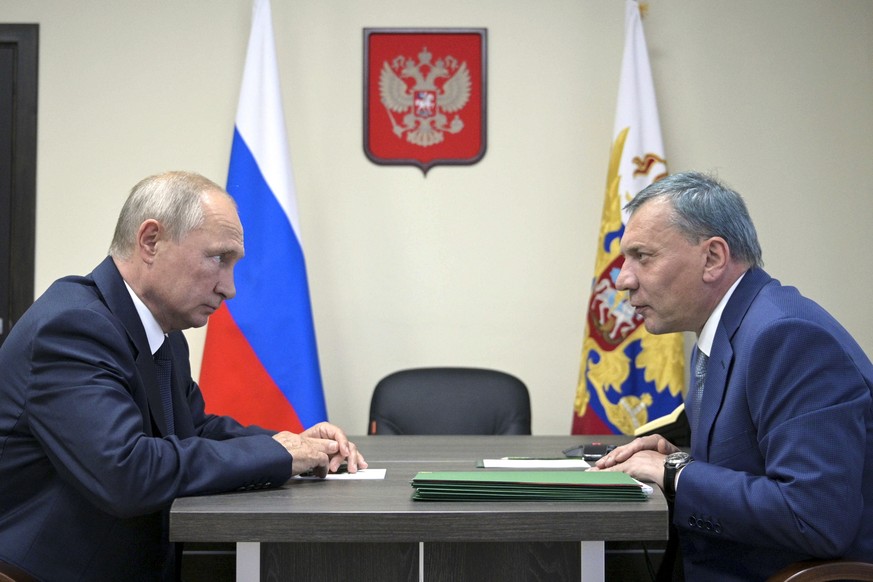 FILE - Russian President Vladimir Putin, left, listens to deputy Prime Minister Yuri Borisov during their meeting after visiting the Zaliv shipyard in Kerch, Crimea, on July 20, 2020. Russian Presiden ...