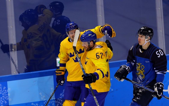 epa06539735 Anton Lander (L) of Sweden celebrates after scoring with his teammate Linus Omark (C) of Sweden, with Miika Koivisto of Finland (R) during the Men&#039;s Ice Hockey Preliminary Round match ...