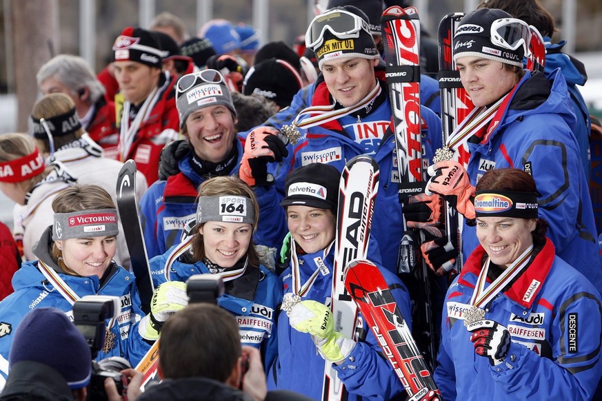 The Swiss team celebrates after clinching the bronze medal of the Nations Team event, at the World Alpine Ski Championships in Are, Sweden, Sunday, Feb. 18, 2007. The athletes are, on top Daniel Albre ...