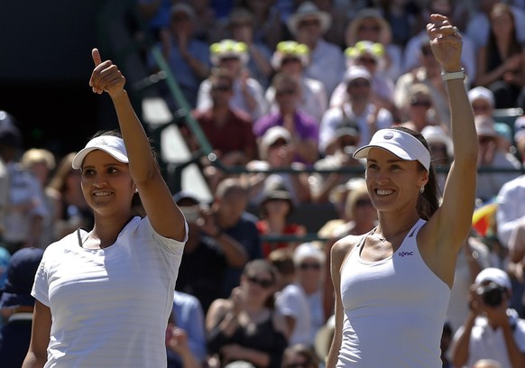 Martina Hingis of Switzerland, right celebrates with partner Sania Mirza of India as they win their women&#039;s semifinal doubles match against Raquel Kops-Jones of the United States and Abigail Spea ...