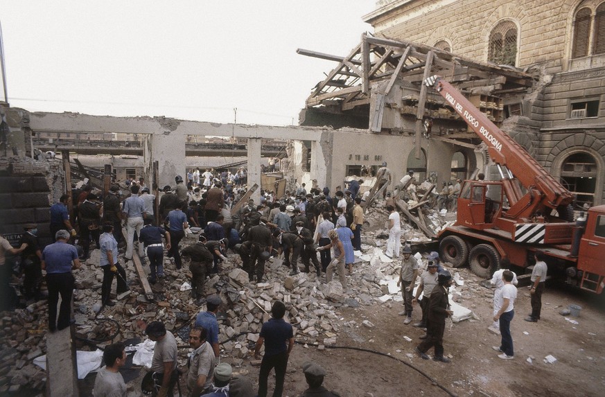 FILE -- In this file photo taken on Aug. 2, 2011 people search debris after a powerful bomb blasted the train station of Bologna, Italy. As Europe worries over resurgent far-right extremism in the aft ...