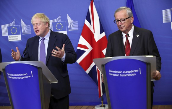 British Prime Minister Boris Johnson and European Commission President Jean-Claude Juncker make prepared statements during a press point at EU headquarters in Brussels, Thursday, Oct. 17, 2019. Britai ...