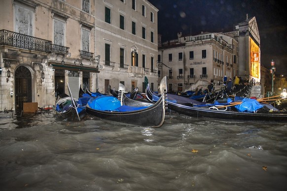 Stranded gondolas float adrift over the flooded banks, in Venice, Wednesday, Nov. 13, 2019. The mayor of Venice is blaming climate change for flooding in the historic canal city that has reached the s ...