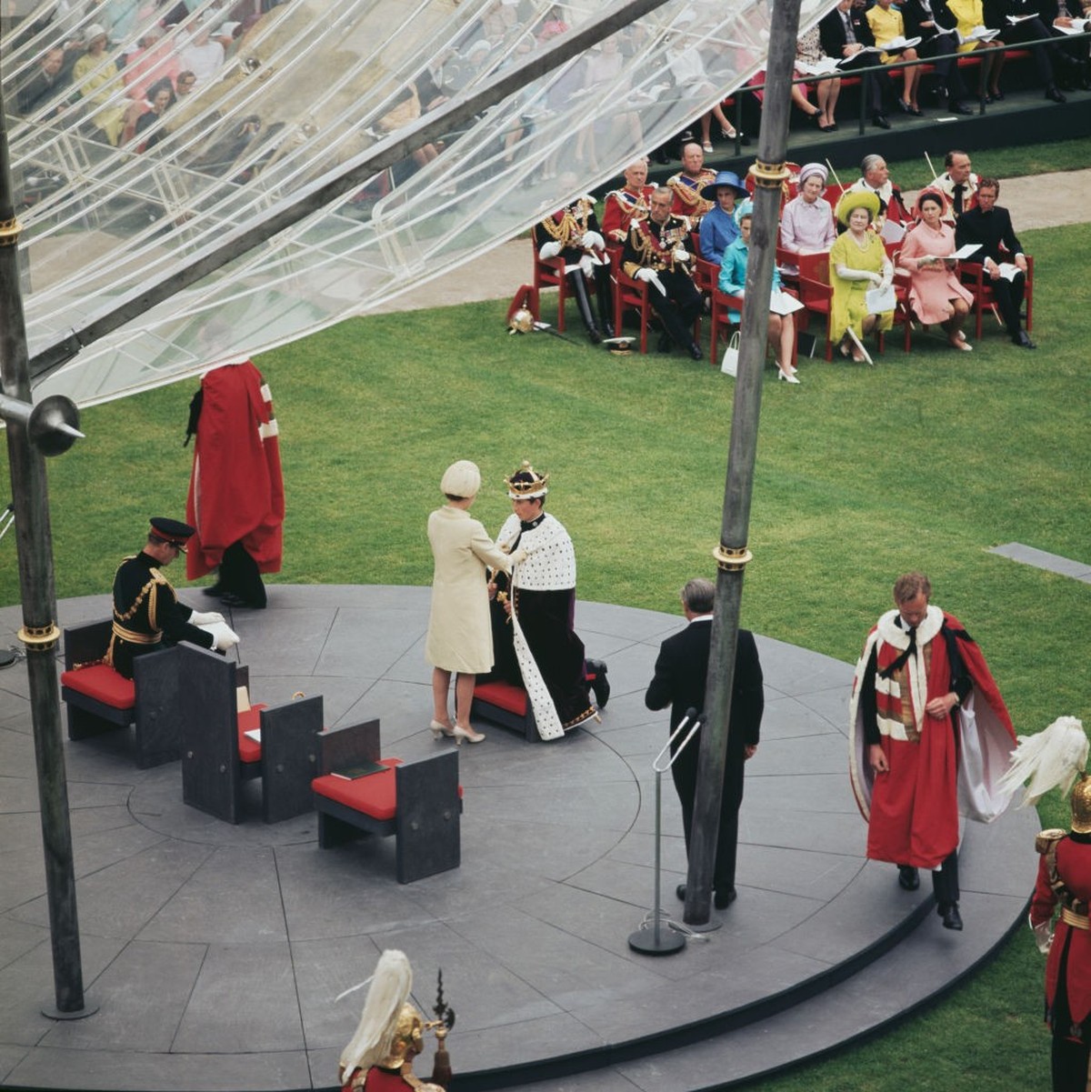 A high-angle view of British Royals Charles, Prince of Wales, Elizabeth II, and Prince Philip, Duke of Edinburgh, during the Prince of Wales investiture ceremony, held at Caernarfon Castle in Caernarf ...