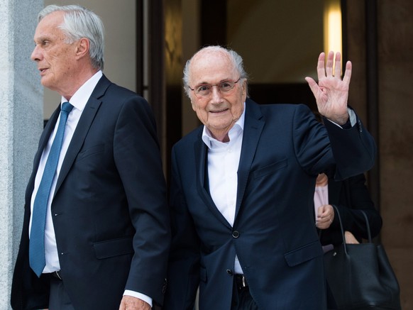 epa10001905 The former president of the World Football Association (Fifa), Joseph Blatter (R) and his lawyer Lorenz Erni (L) leave the Swiss Federal Criminal Court after the first day of his trial, in ...