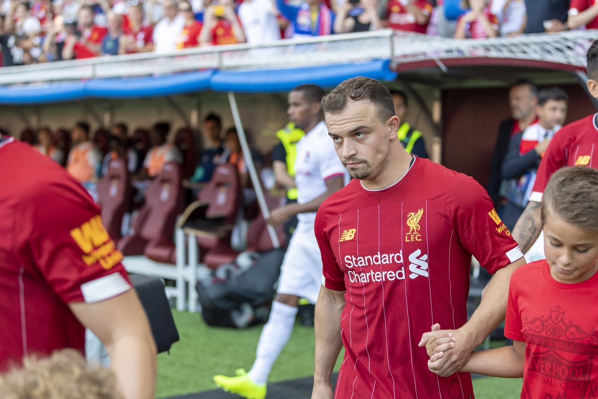 Liverpool's Xherdan Shaqiri walks to the pitch together with the children who act as players escorts, during a friendly soccer match between Liverpool FC and French Olympique Lyonnais at the Stad ...