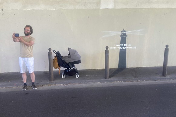 A man makes a selfie by an artwork by street artist Banksy, Friday, May 30, 2025 in Marseille, southern France. (AP Photo/Bishr Eltoni)
France Banksy
