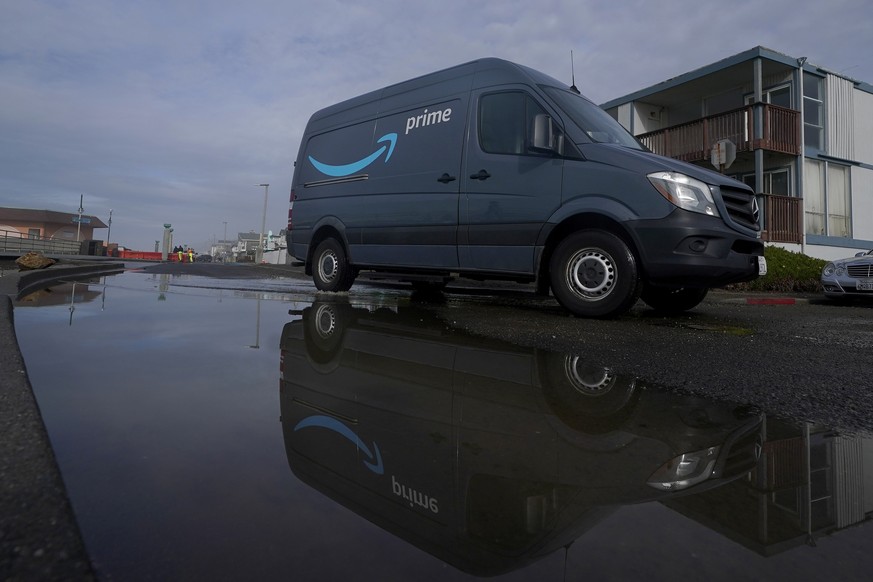 FILE - An Amazon Prime truck drives in Pacifica, Calif., on Dec. 15, 2020. California is suing Amazon, accusing the company of violating the state