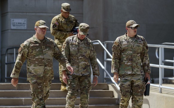 epa12295796 Members of the National Guard leave the DC Armory in Washington, DC, USA, 12 August 2025. US President Trump has ordered the deployment of the National Guard to assist law enforcement in t ...