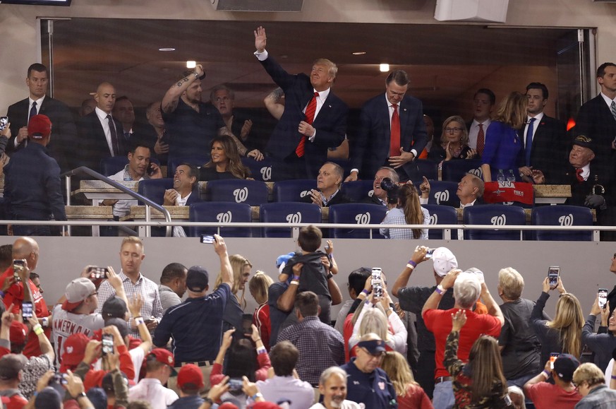 epa07955286 US President Donald J. Trump (top C) waves to the crowd between innings as the Washington Nationals play the Houston Astros in their MLB 2019 World Series game five at Nationals Park in Wa ...