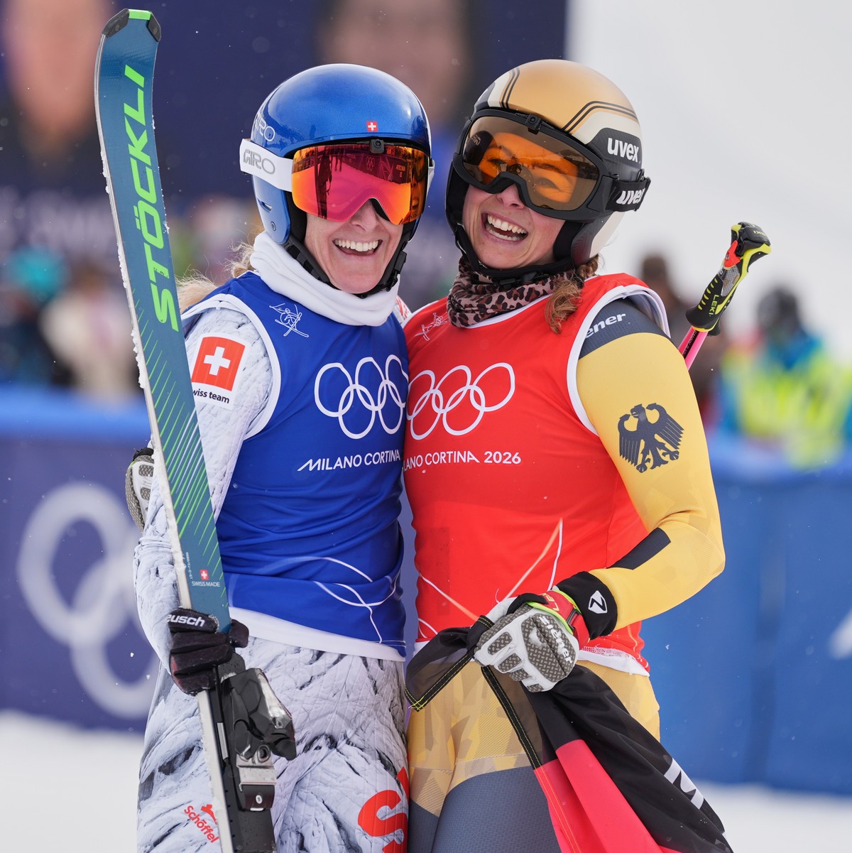 Switzerland's Fanny Smith (3), left, and Germany's Daniela Maier (1) embrace after the women's ski cross finals at the 2026 Winter Olympics, in Livigno, Italy, Friday, Feb. 20, 2026. (A ...