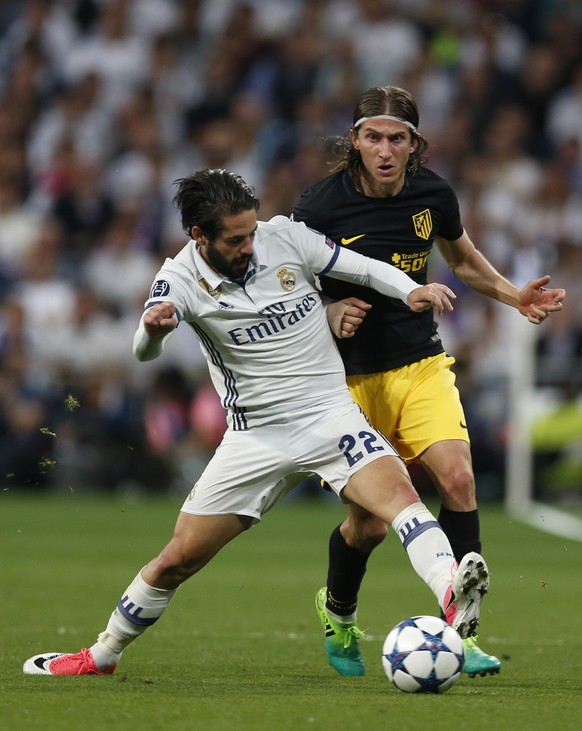 Atletico&#039;s Filipe Luis fights for the ball against Real Madrid&#039;s Isco during the Champions League semifinal first leg soccer match between Real Madrid and Atletico Madrid at the Santiago Ber ...