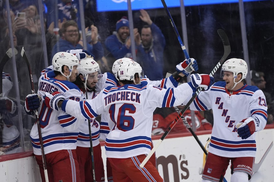 New York Rangers players celebrate center Mika Zibanejad&#039;s goal against the New Jersey Devils during the first period of an NHL hockey game in Newark, N.J., Thursday, Feb. 22, 2024. (AP Photo/Pet ...