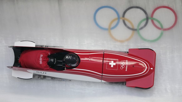 Driver Clemens Bracher and Michael Kuonen of Switzerland take a curve during the two-man bobsled training at the 2018 Winter Olympics in Pyeongchang, South Korea, Friday, Feb. 16, 2018. (AP Photo/Michael Sohn)
