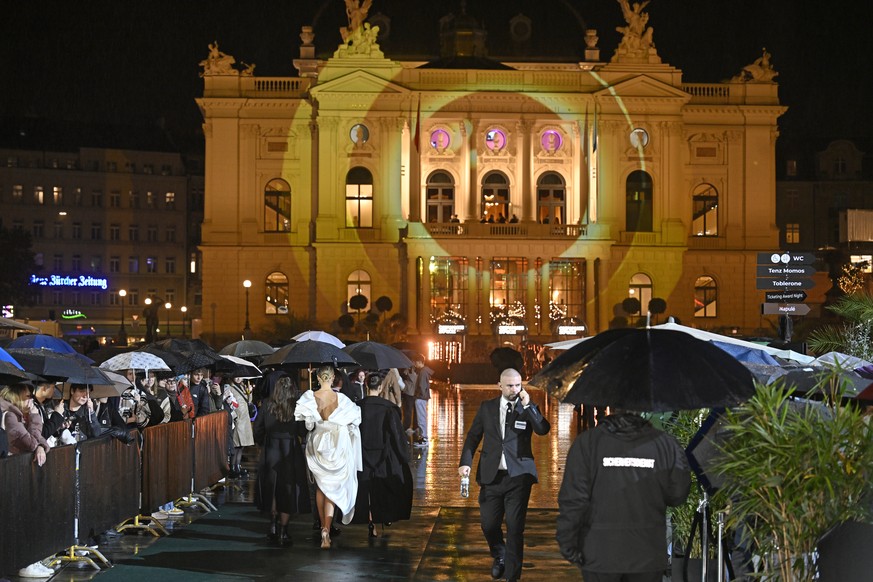 Visitors wait in front of the opera house for the green carpet during the Award Night ceremony of 20th Zurich Film Festival (ZFF) in Zurich, Switzerland, on Saturday, October 12, 2024. The Zurich Film ...