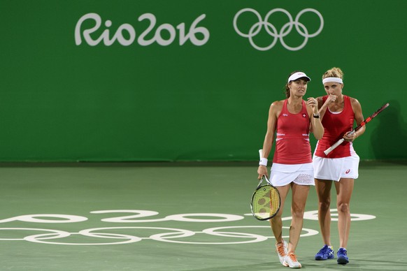 Timea Bacsinszky, right, and Martina Hingis, left, of Switzerland during the women&#039;s semi-final doubles match against Andrea Hlavackova and Lucie Hradecka from Czech Republic at the Olympic Tenni ...