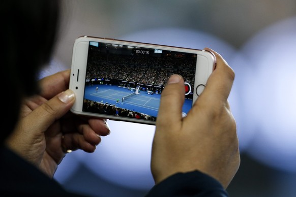 epa05754105 A spectator uses her phone during the Men&#039;s Singles semi-final match between Rafael Nadal of Spain and Grigor Dimitrov of Bulgaria at the Australian Open Grand Slam tennis tournament  ...