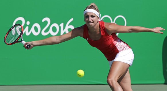 Timea Bacsinszky, of Switzerland, reaches for a return to Zhang Shuai, of China, during the 2016 Summer Olympics in Rio de Janeiro, Brazil, Saturday, Aug. 6, 2016. (AP Photo/Charles Krupa)