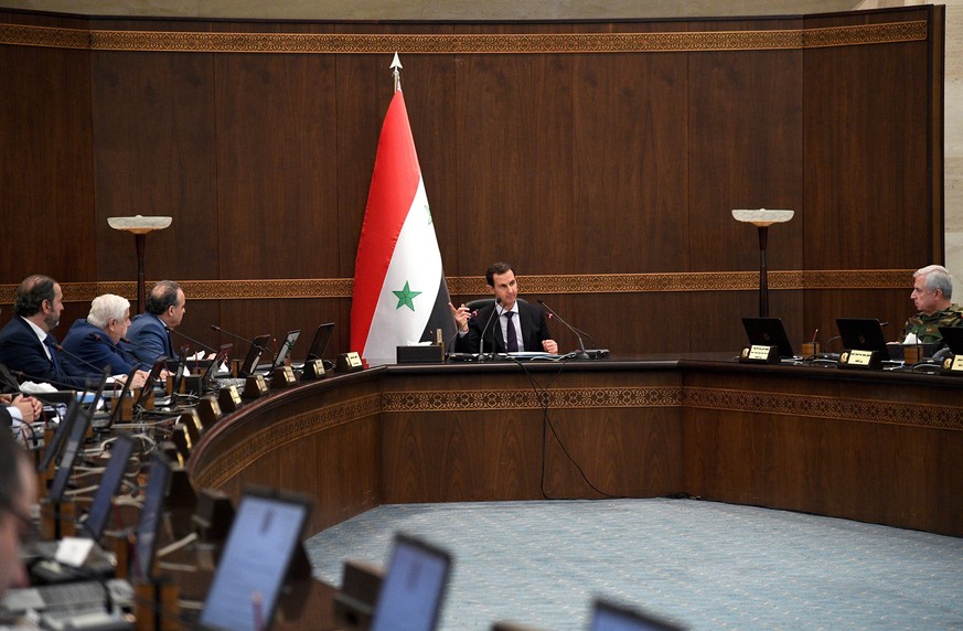 epa07570018 A handout photo made available by the official Syrian Arab News Agency (SANA) shows Syrian President Bashar Assad (C) chairing a cabinet meeting in Damascus, Syria, 14 May 2019. EPA/SANA H ...