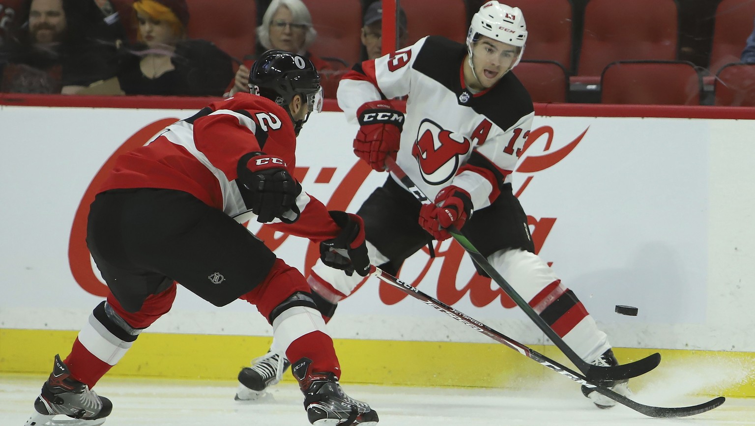 New Jersey Devils center Nico Hischier (13) shoots the puck past Ottawa Senators defenseman Dylan DeMelo (2) during first period NHL hockey action in Ottawa on Monday, Jan. 27, 2020. (Fred Chartrand/T ...