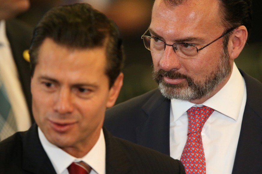 Mexico&#039;s Foreign Minister Luis Videgaray (R) is seen behind Mexico&#039;s President Enrique Pena Nieto during the 25th Session of the General Conference of the Agency for the Prohibition of Nucle ...