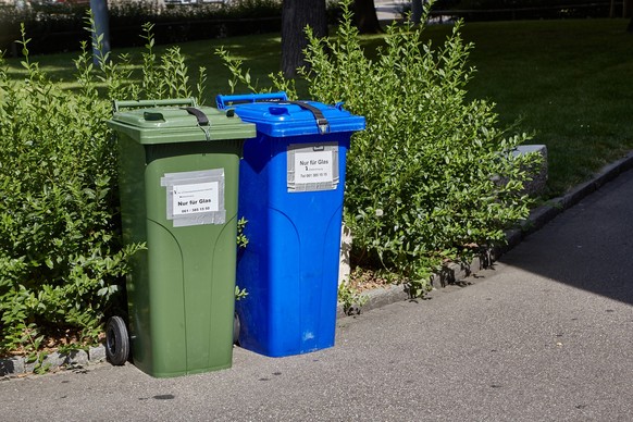 Basel, Switzerland: Trash containers for municipal waste on an green street selective bins or recyclables collection xkwx bin, trash, trashcan, dumpster, can, plastic, garbage, waste, dispose, disposa ...