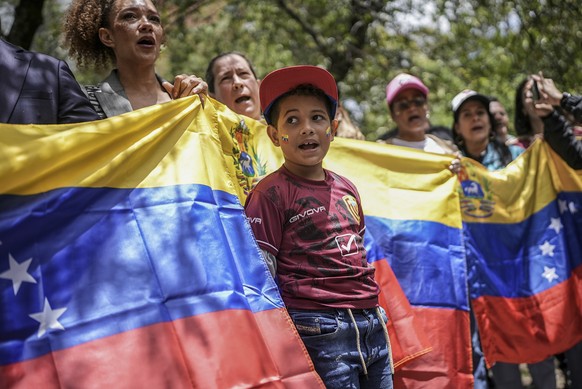 Demonstrators hold a Venezuelan flag outside that nation&#039;s consulate to protest the contested presidential election results in Bogota, Colombia, Thursday, Aug. 1, 2024. (AP Photo/Ivan Valencia)