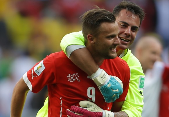 Switzerland&#039;s Haris Seferovic, front, and goalkeeper Diego Benaglio celebrate after the group E World Cup soccer match between Switzerland and Ecuador at the Estadio Nacional in Brasilia, Brazil, ...