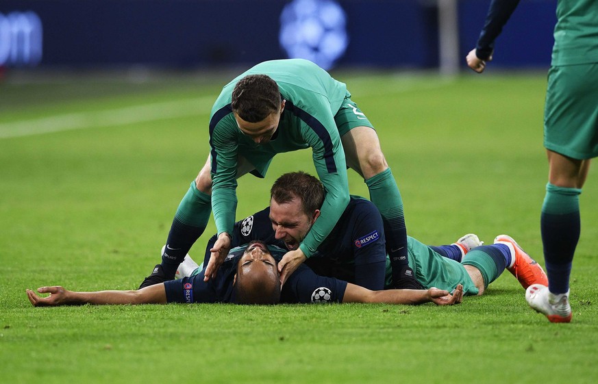 epa07556653 Lucas Moura (bottom) and Christian Eriksen (C) of Tottenham Hotspur celebrate after the UEFA Champions League semi final, second leg soccer match between Ajax Amsterdam and Tottenham Hotsp ...