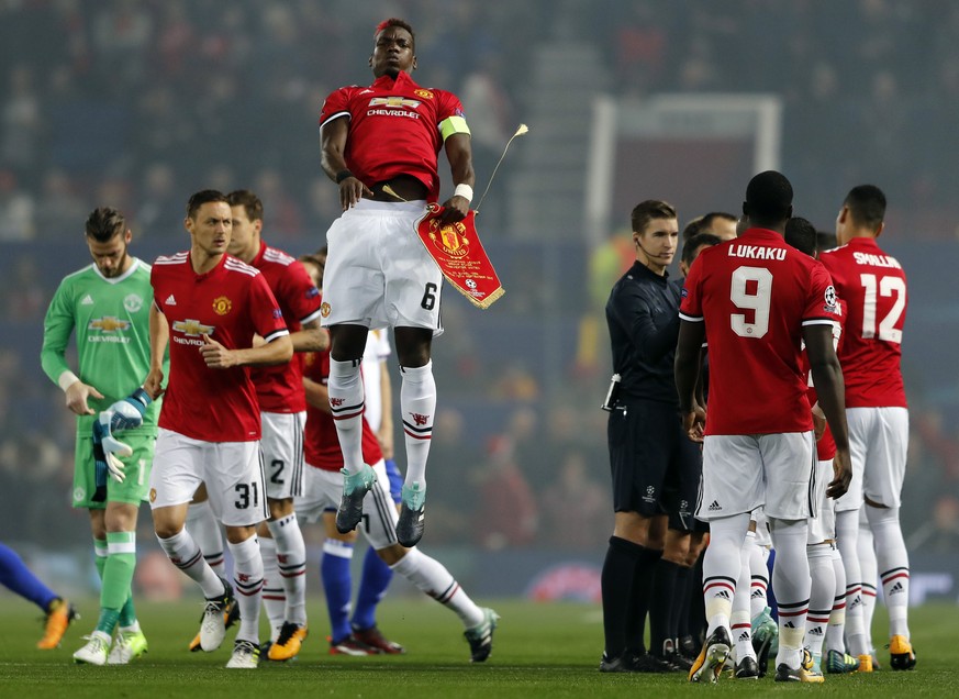 Manchester United&#039;s team captain Paul Pogba jumps at the beginning of the Champions League group A soccer match between Manchester United and Basel, at the Old Trafford stadium in Manchester, Tue ...