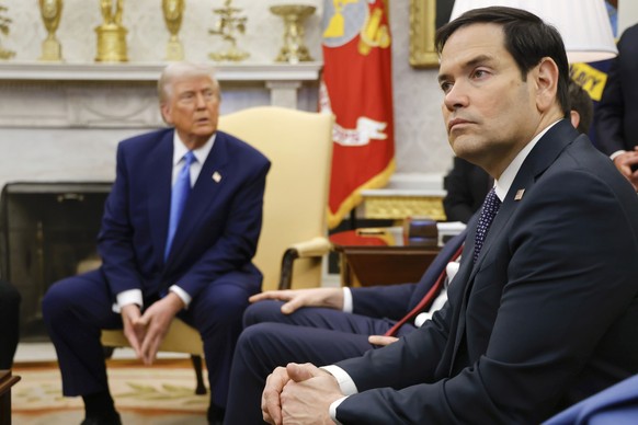 Secretary of State Marco Rubio, right, listens as President Donald Trump, left, meets with France&#039;s President Emmanuel Macron in the Oval Office of the White House in Washington, Monday, Feb. 24, ...