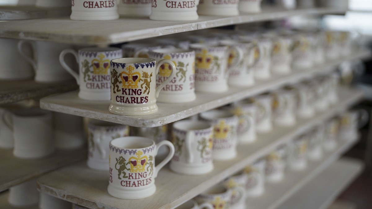 Britain's King Charles III themed mugs on display, during the production of hand-decorated pieces from the forthcoming Coronation collection, at the Emma Bridgewater Pottery Factory in Stoke on T ...