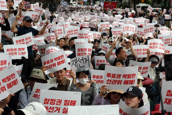 epa13020411 Protesters hold a rally in Seoul, South Korea, 06 June 2026, denouncing ballot paper shortages at some polling stations during the 03 June local elections and demanding a revote. EPA/YONHA ...