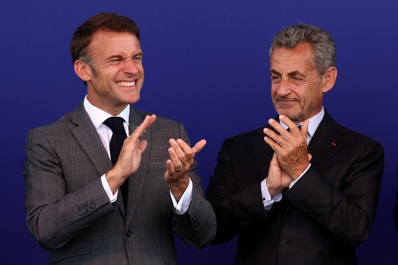 epa11434047 French President Emmanuel Macron (L) and former French President Nicolas Sarkozy (R) applaud during the inauguration of the new Saint-Denis Pleyel metro station, in Saint-Denis, near Paris ...