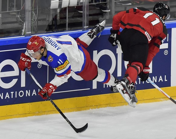 Russia&#039;s Sergei Andronov, left, and Canada&#039;s Travis Konecny collide as they struggle for a puck during the Ice Hockey World Championships semifinal match between Canada and Russia in the LAN ...