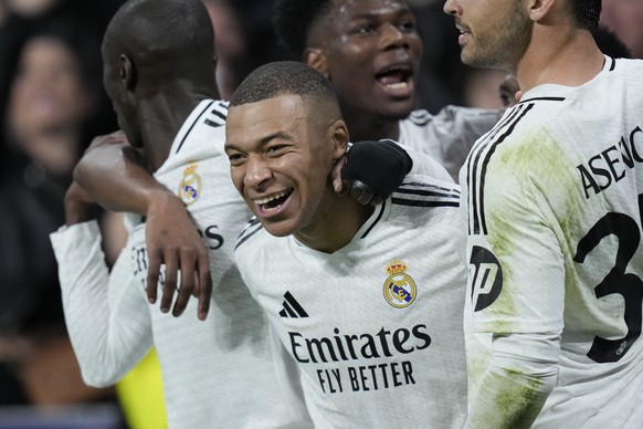 Real Madrid&#039;s Kylian Mbappe celebrates after scoring his side&#039;s second goal during the Champions League playoff second leg soccer match between Real Madrid and Manchester City at the Santiag ...