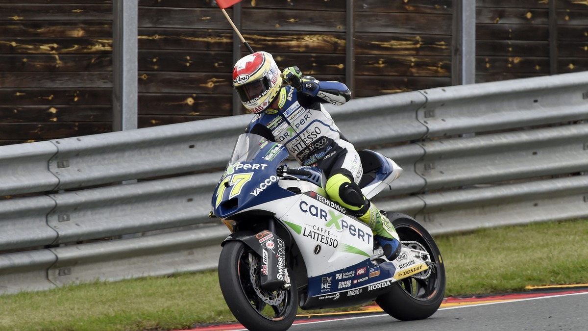 Dominique Aegerter from Switzerland celebrates winning the Moto2 race at the Sachsenring circuit in Hohenstein-Ernstthal, Germany, Sunday, July 13, 2014. (AP Photo/Jens Meyer)