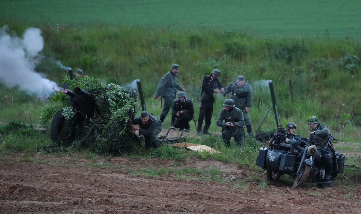 epa08454179 Members of military historical clubs dressed in Nazi and Soviet Army World War II-era uniforms, perform in a reenactment show of a WWII battle at the Open air museum 'Stalin's li ...
