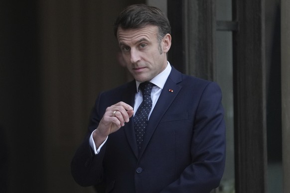 France&#039;s President Emmanuel Macron waits for Romania&#039;s Interim President Ilie Boloja, before a meeting on European security, Wednesday, Feb. 19, 2025, at the Elysee Palace in Paris. (AP Phot ...