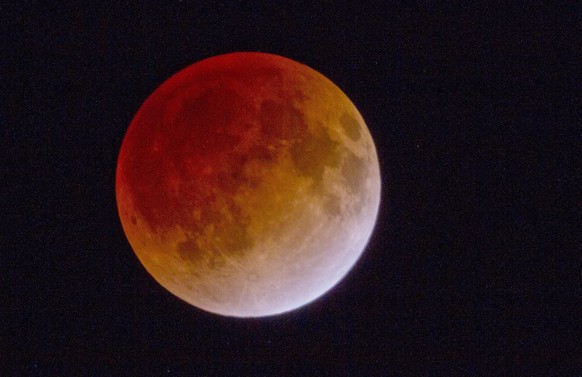 epa03030264 View of a total lunar eclipse as seen from Misaki city, Chiba province, Japan, 11 December 2011. The total lunar eclipse was viewed on the Japanese main island of Honshu. The phenomenon oc ...