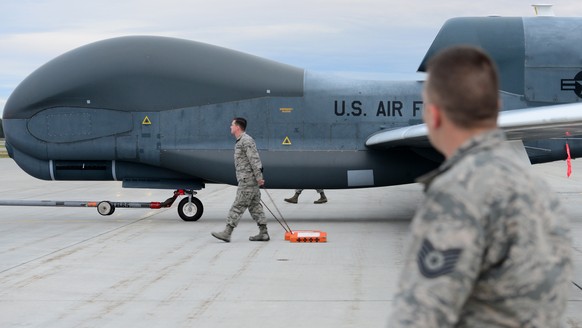 epa07659383 A handout photo made available by the US Defense Visual Information Distribution Service (DIVIDS) showing a team of 12th Aircraft Maintenance Unit Airmen walking beside an RQ-4 Global Hawk ...