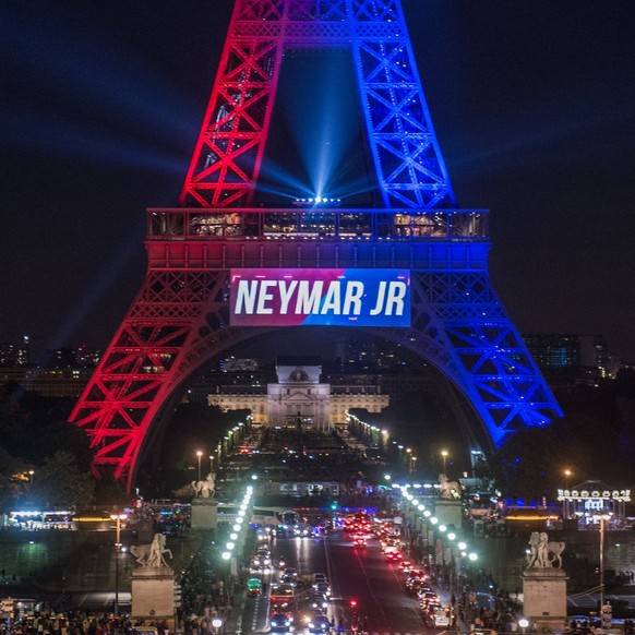 epa06127465 The Eiffel Tower is illuminated in Red and blue (the colors of the Paris Saint Germain soccer team) to celebrate the arrival of the Brazilian striker Neymar Jr on the day of his official p ...