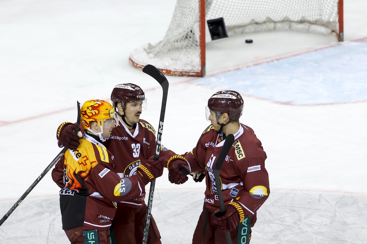 Geneve-Servette's forward Alessio Bertaggia #33 celebrates his goal with his teammates Geneve-Servette's forward Sakari Manninen, left, and Geneve-Servette's forward Valtteri Filppula,  ...