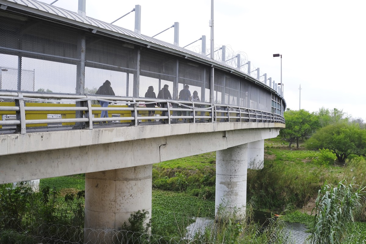 Pedestrians cross Gateway International Bridge on Monday, March 6, 2023, in Brownsville, Texas, into Matamoros, Mexico. Gunmen kidnapped four U.S. citizens who crossed into Mexico from Texas last week ...