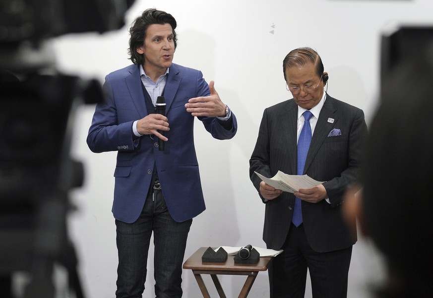 Olympic Games Executive Director Christophe Dubi, left, accompanying Toshiro Muto, CEO of the Tokyo Organizing Committee of the Olympic and Paralympic Games, right, speaks after a working level meetin ...