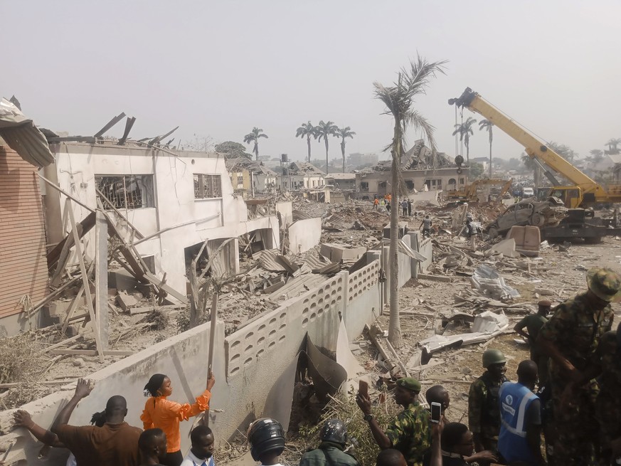 People gather at the site of an explosion in Ibadan, Nigeria, Wednesday, Jan. 17, 2024. Several people died and many others were injured after a massive blast caused by explosives rocked more than 20  ...
